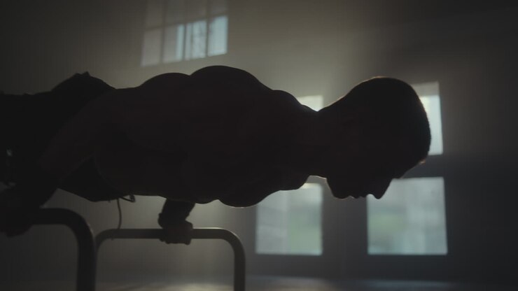 Man Performing Push-ups on a Bench in a Gym