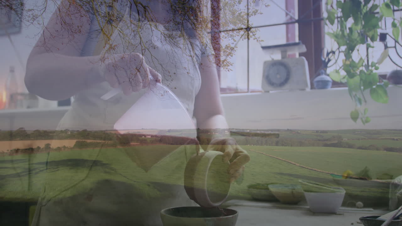 Mid-adult woman pouring milk into bowl in cooking scene, showcasing animated farmland overlay