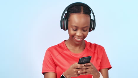 Headphones,-phone-and-black-woman-in-studio-typing