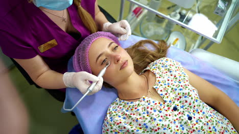 cosmetology face procedure in cosmetic salon. woman getting facial treatment at cosmetic beauty spa clinic