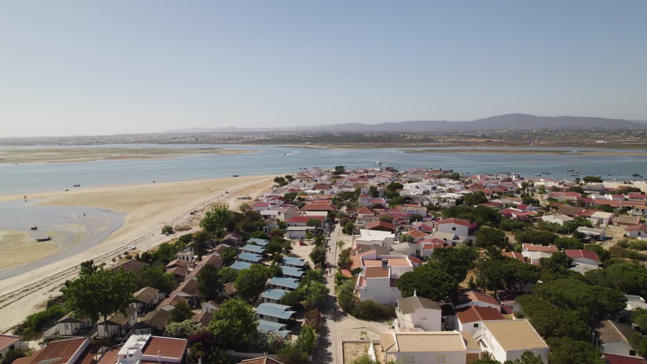 Drone flies backwards over Small town in Armona Island, Olhão. Portugal