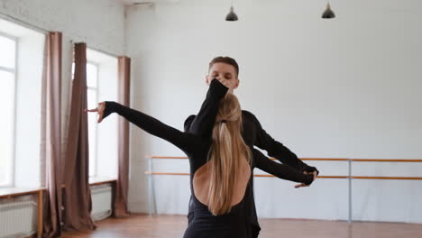 professional dancers practicing ballroom dance in a studio