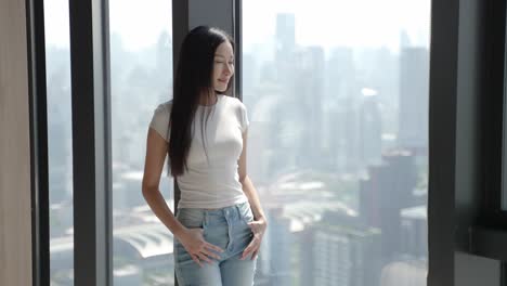 woman by window with city view