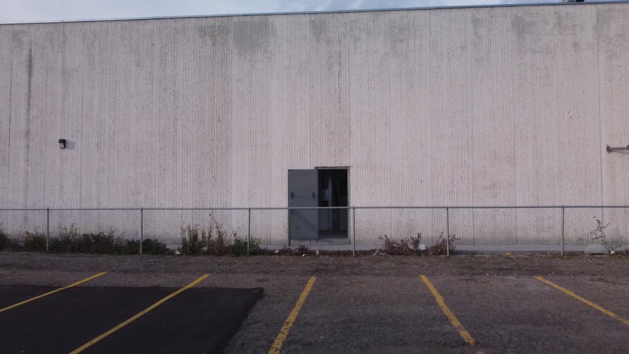 Industrial building with open door pull out parking aerial drone