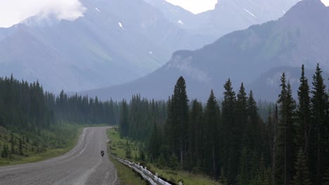 Lone-cyclist-on-dirt-road-742-in-Kananaskis,-Canadian-Rockies