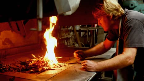 blacksmith putting log sticks in fireplace 4k