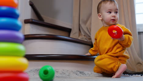 baby playing with toys on stairs