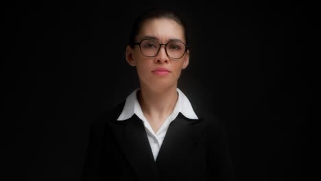 beautiful brunette in business clothes and glasses asks to speak louder.