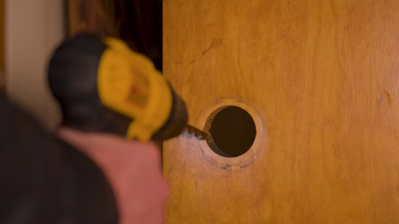 Using a drill bit to increase the size of the hole