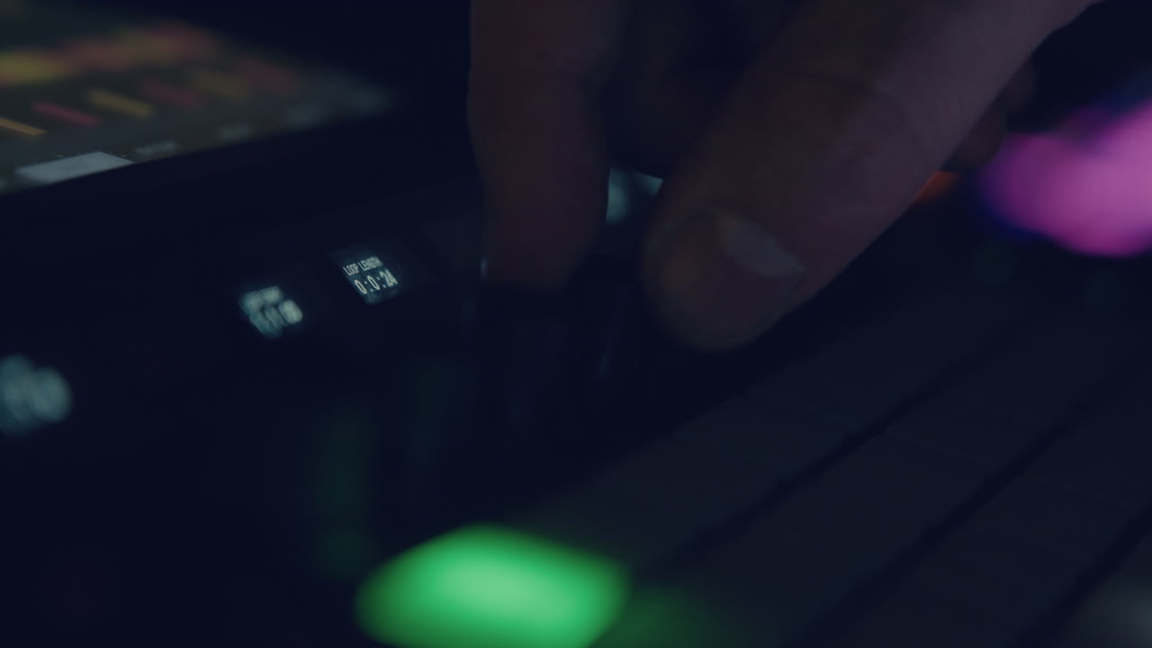 Close-up of Hand Adjusting Knob on Music Production Controller
