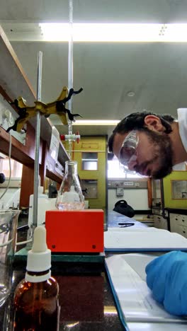 scientist using erlenmeyer flask in experiment