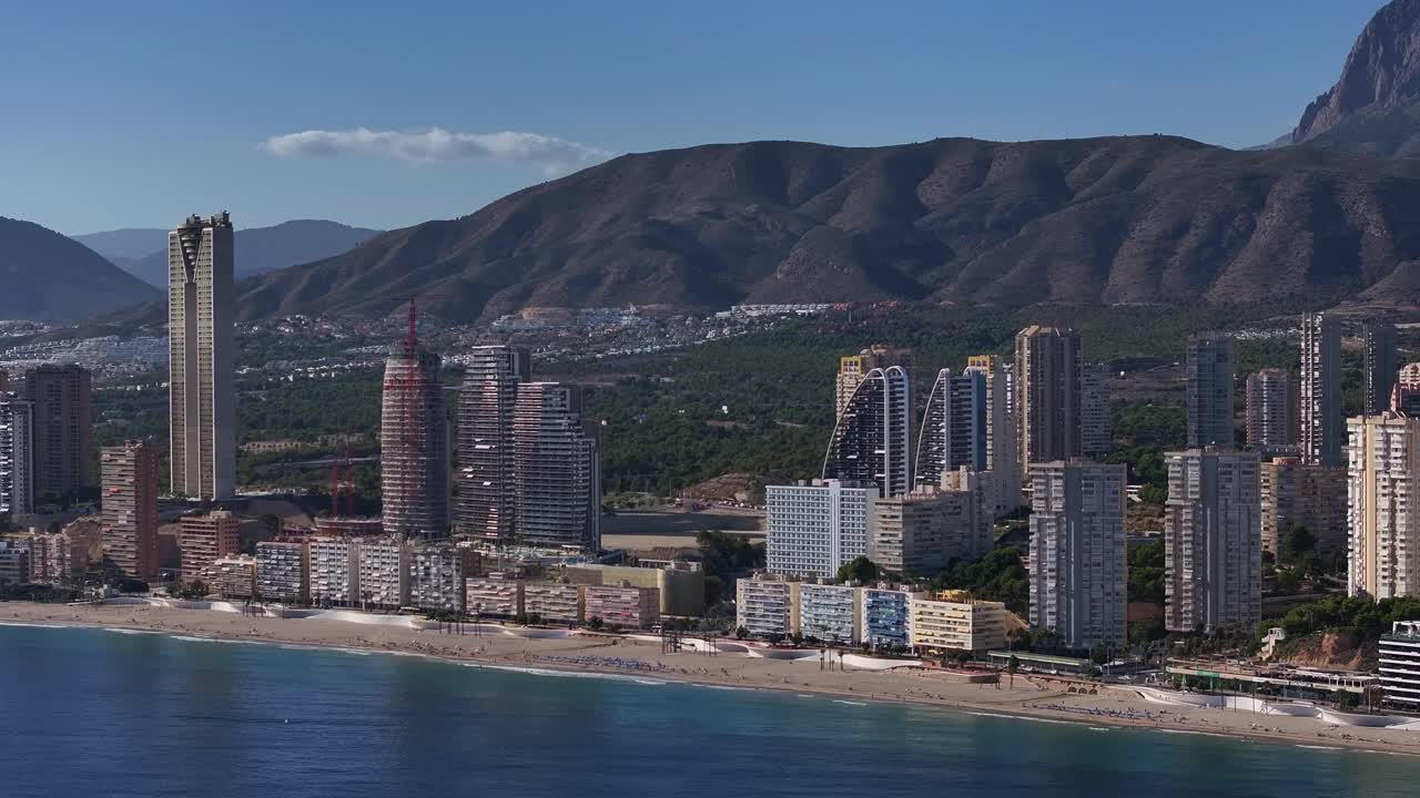 Benidorm, Spain coastline with modern buildings, mountain backdrop, and beach view