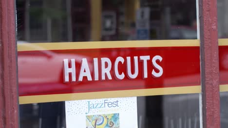 Haircuts-sign-in-Lansing,-Michigan-Old-Town-district-with-stable-establishing-shot