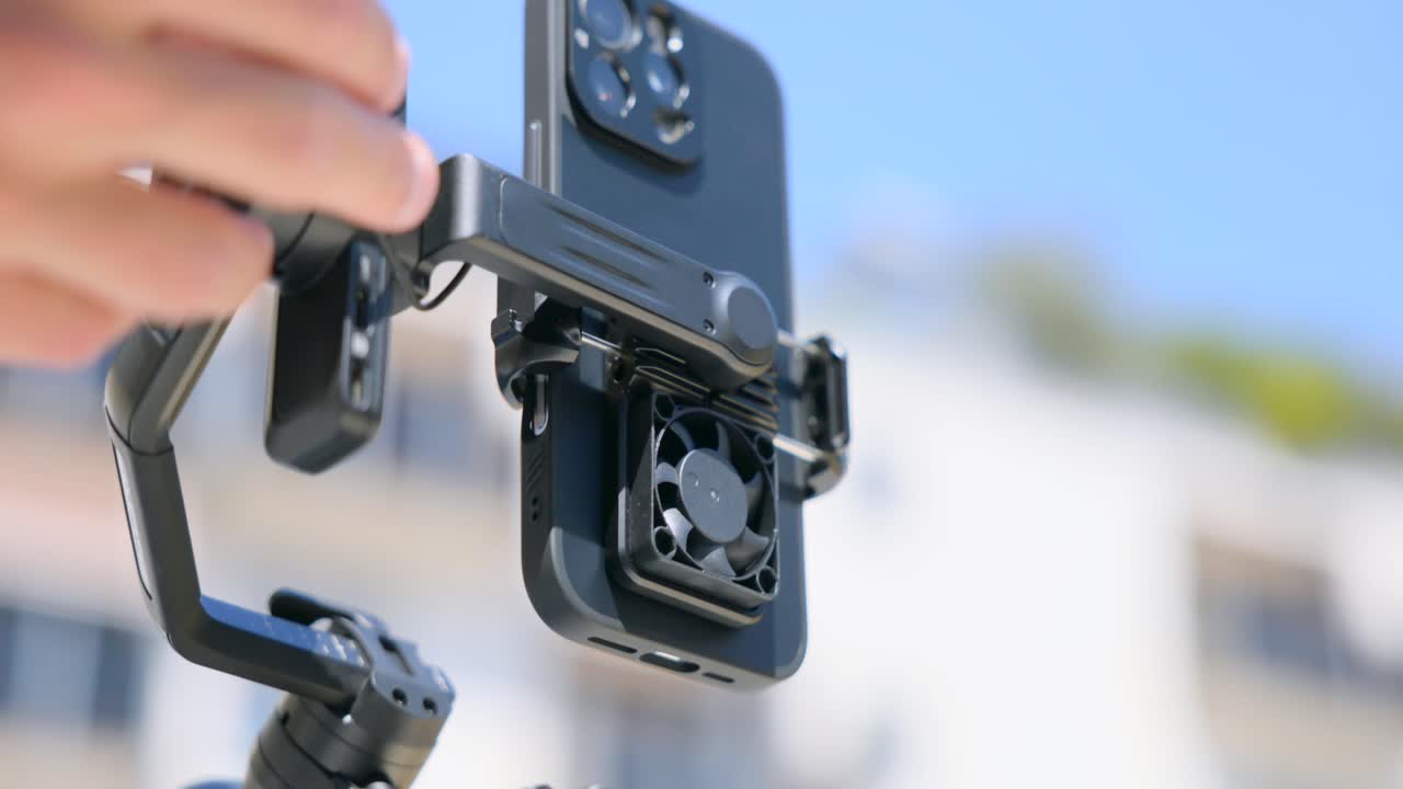 FeiyuTech SCORP Mini 3-Axis Gimbal Stabilizer With A Smartphone Attached. Close-up Shot