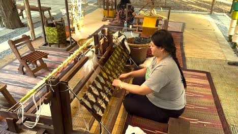 woman weaving silk in khao yai, thailand