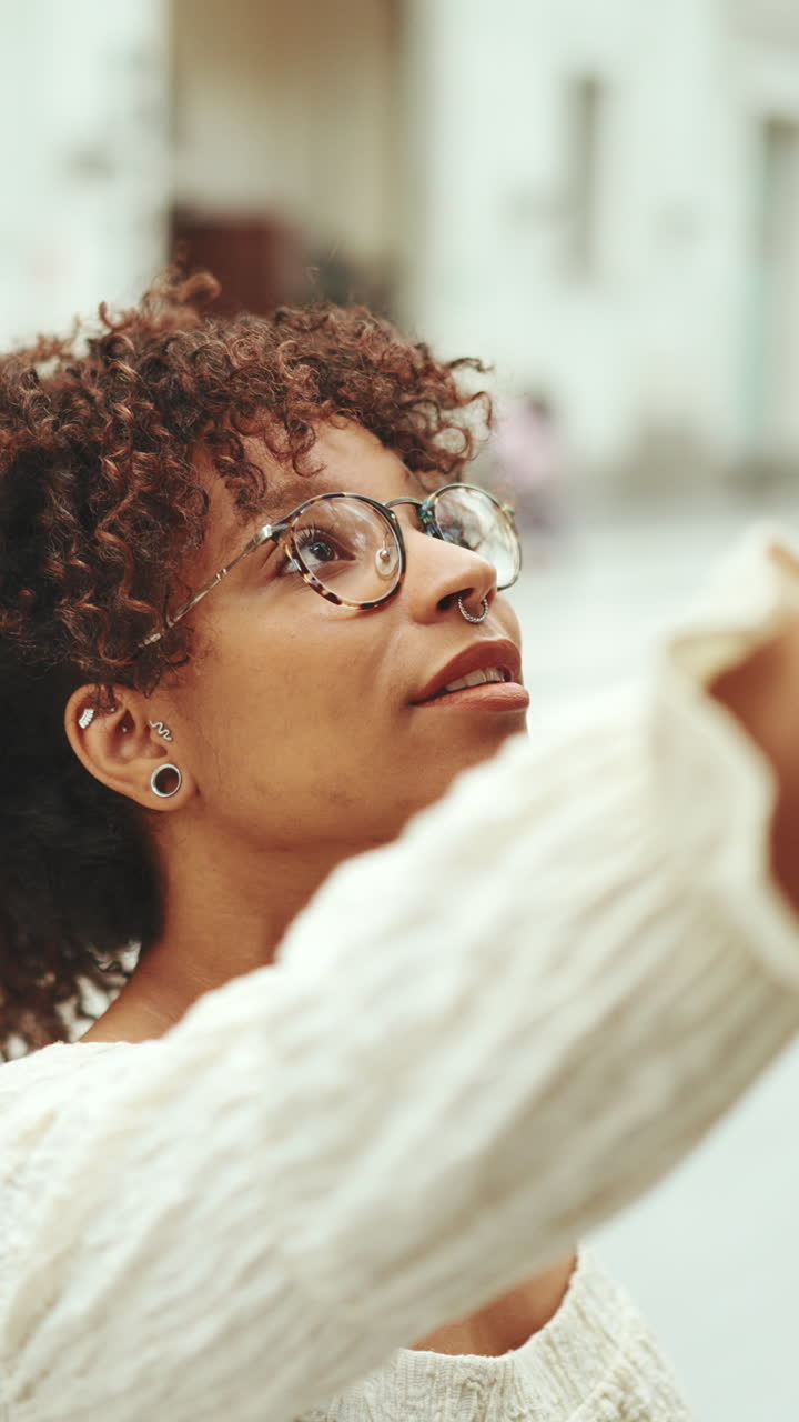 Portrait of a woman with curly hair and glasses