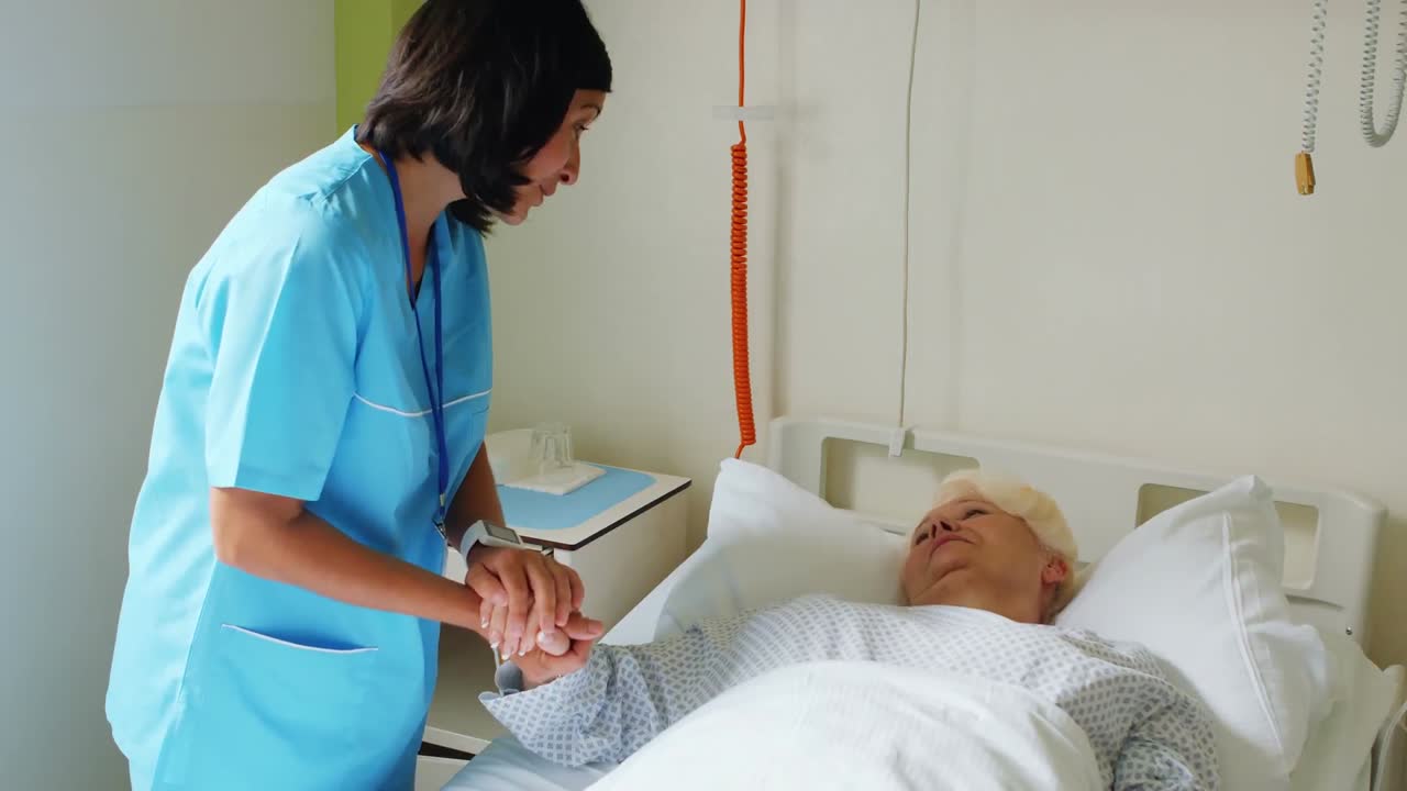 Enfermeira consolando paciente idoso com médico