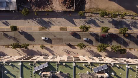 Aerial-top-down-of-city-life-around-Chacarita-Area-of-Buenos-Aires-Argentina-showing-cars,-buildings-and-people