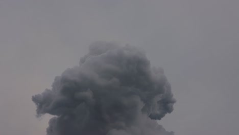 industrial black hot smoke pushed into the air on a cloudy grey day