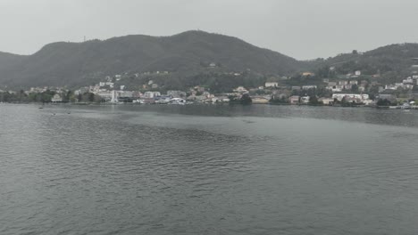 aerial reveal rotation on the shore of lake como with a view of the city of como