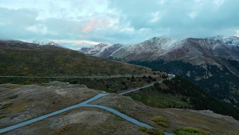 aerial footage capturing the sun setting over the snow-capped peaks and valleys of independence pass