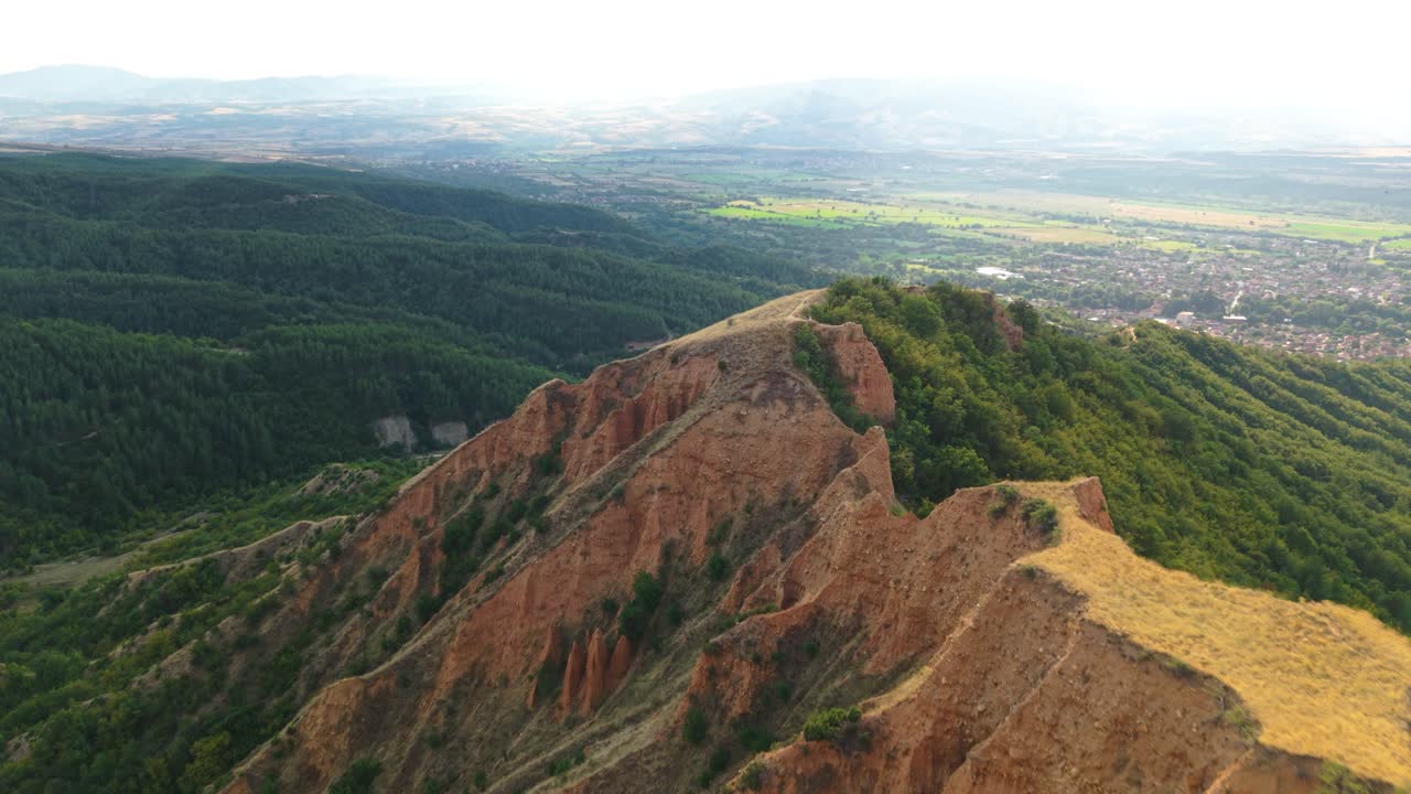 Drone footage shows the natural sandstone formations at the Stob Pyramids Bulgaria with panoramic rural views