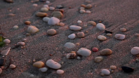 cerca de las piedras descansan en la playa al atardecer