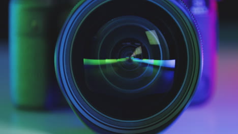 lens of photo camera reflects colorful rainbow colors prism in glass, slow camera movement