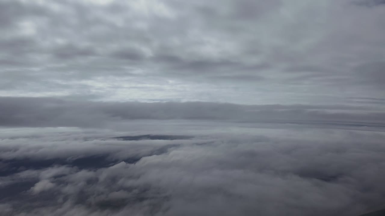 Aerial cloudscape taken from a jet airplane cockpit while flying between layers of ethereal stratus clouds. Hyperlapse accelerated x5