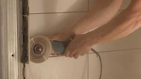 cutting a wall with an angle grinder in a bathroom renovation