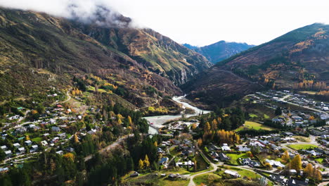 Aerial-View-Of-Arthurs-Point-Suburb-Houses,-River-And-Mountain-In-Queenstown,-South-Island,-New-Zealand