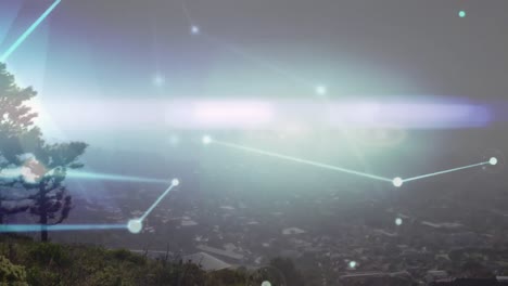 animation of network of connections and glowing light trail against aerial view of cityscape