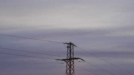 Medium-shot-of-an-electricity-pylon-at-sunrise