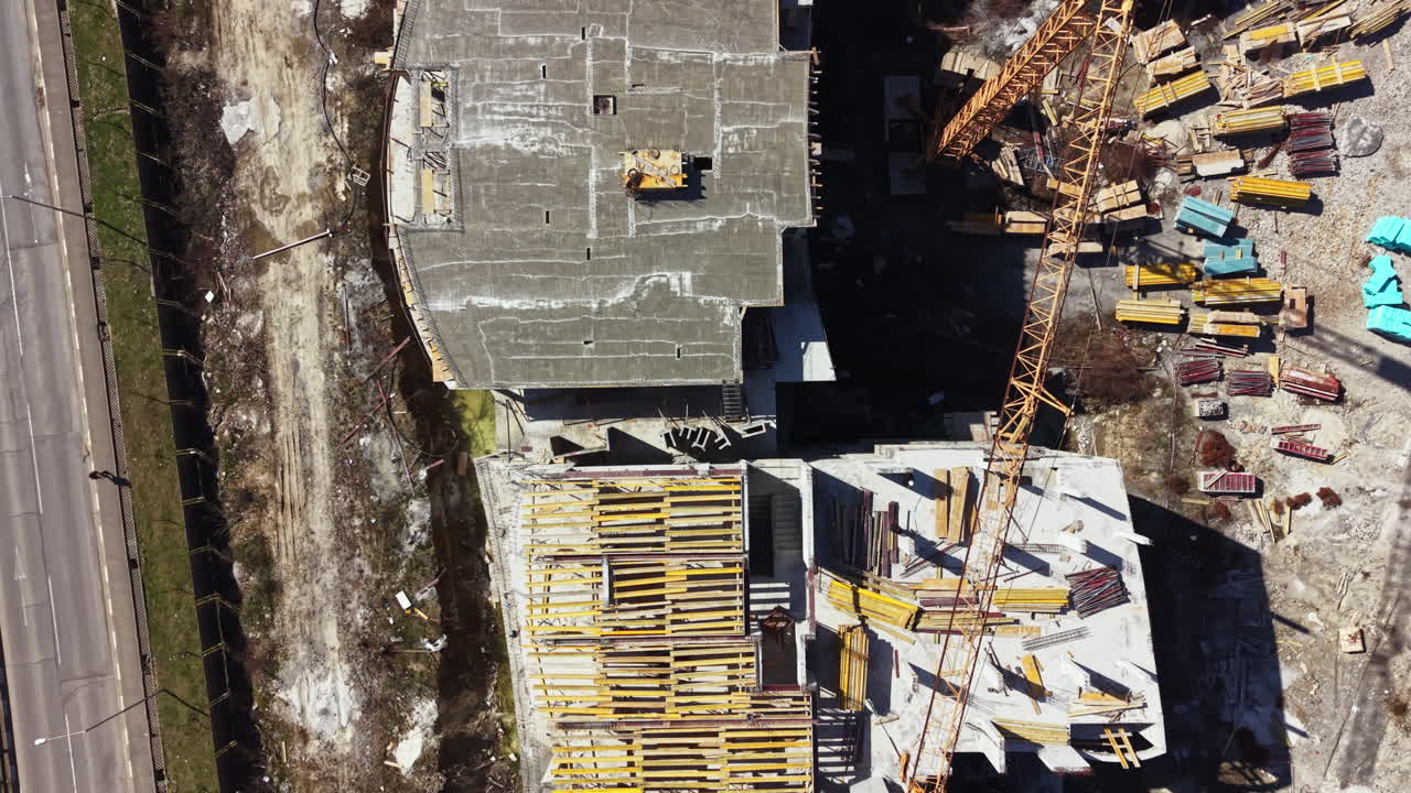 Construction site shows building structure with wooden frameworks in an urban area during the daytime