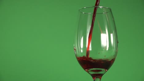 Wine-being-slowly-poured-on-a-glass,-on-a-chroma-background