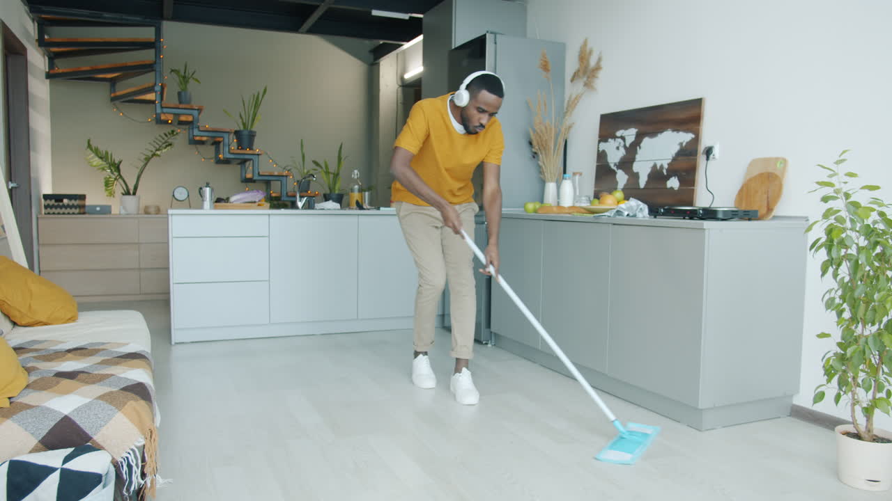 Man Mopping and Dancing in Modern Kitchen