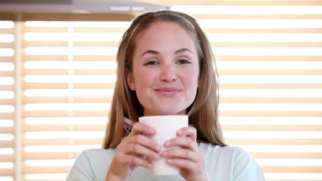 a woman drinking from a mug