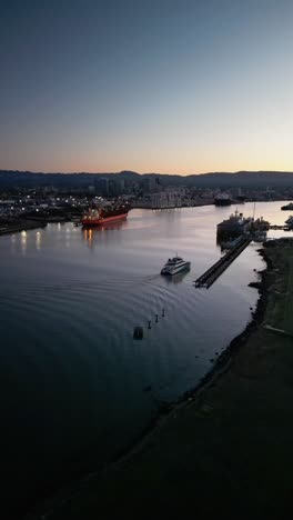 Sunrise vertical drone footage over West Alameda’s harbor, showcasing the contrast between urban structures and open water.