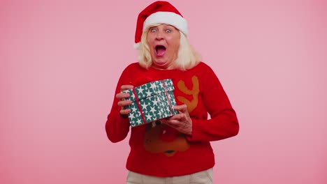 grandmother woman in sweater santa christmas getting present gift box expressing amazement happiness