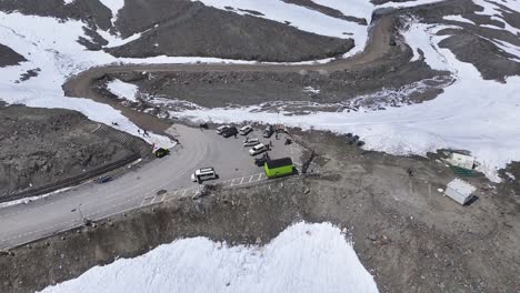 aerial drone shot showcasing the pristine white snow blanketing the rugged mountains of shinkula pass.