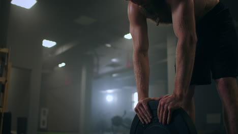 sweaty tired athlete with vapor in slow motion in the gym rests after training. restoring strength and breathing. motivation and sport