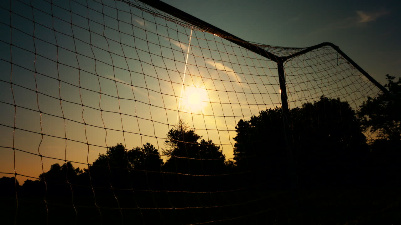 Sunrise through a football net