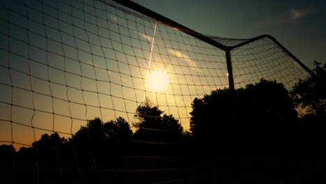 sunrise through a football net