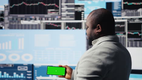 african american business leader uses green screen next to kpi metrics