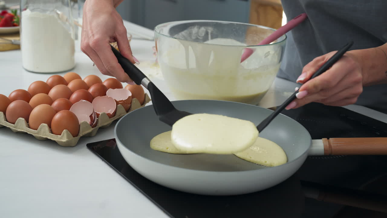 Healthy pancakes preparation in the frying pan. Close up