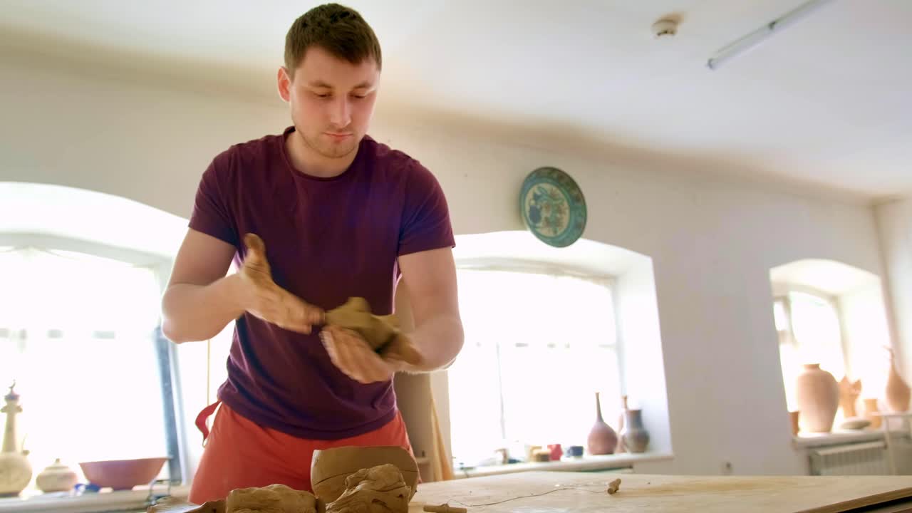 A Skillful Artisan Shaping Clay: A Crafting Journey from Raw Material to Art, Demonstrating the Beauty and Technique of Pottery Creation in a Serene Studio Environment