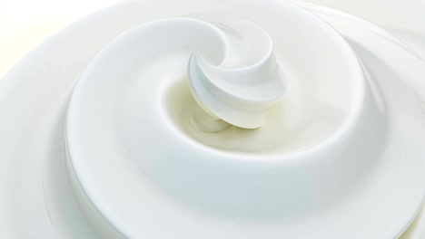 rotating white cream. close-up view. looped animation.