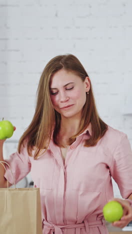 woman with fresh apple eyes. portrait of happy woman closing eyes by apples vertical video