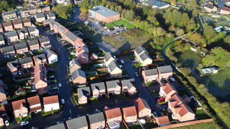 aerial view above new build modern housing estate property rooftops england zoom out