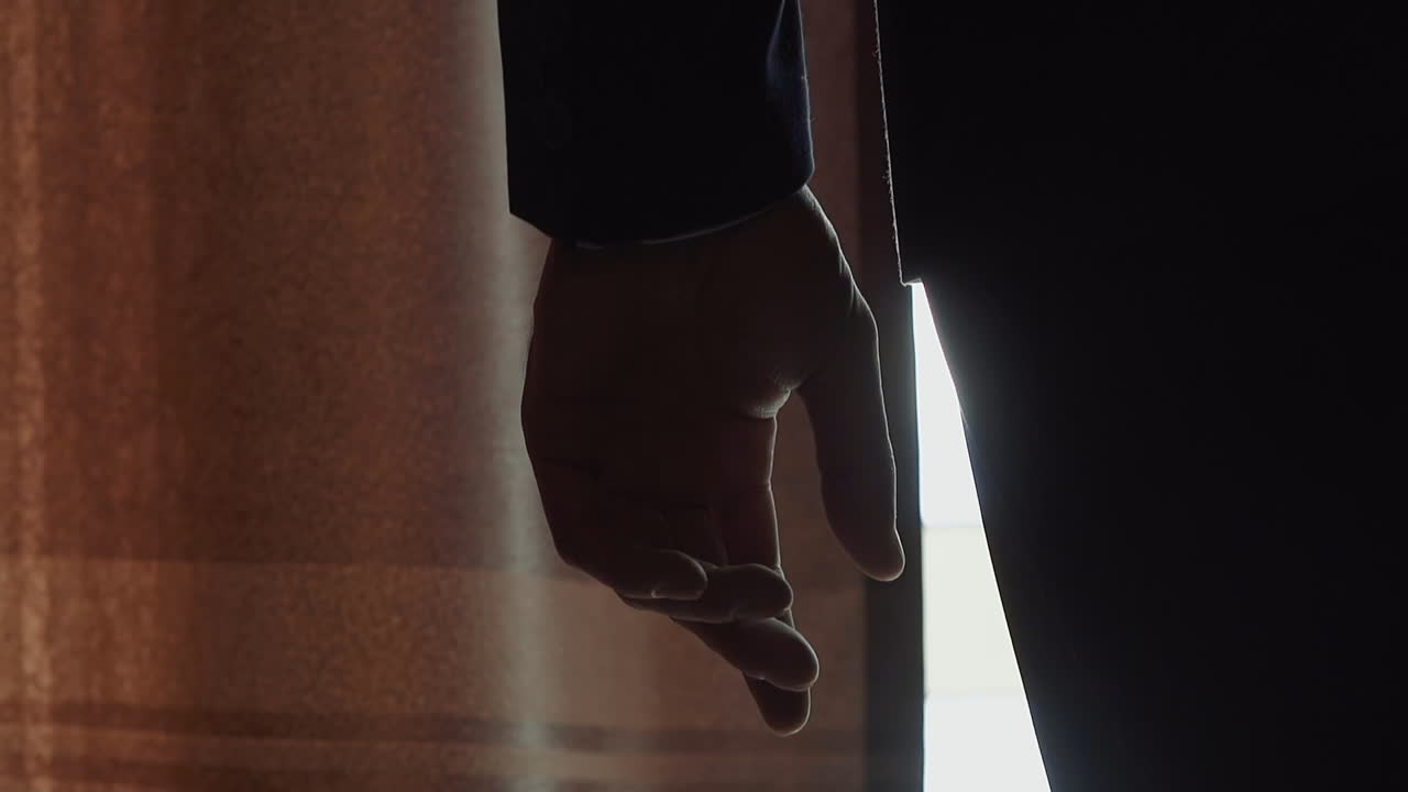 Silhouette of nervous businessman in semi-dark hotel room